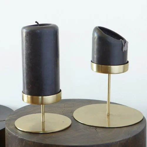 deux bougeoirs dorés avec leurs bougies noires
