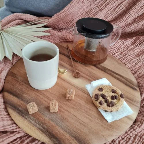 Planche avec un cookie, du sucre, un mug, du miel et deux cuillères